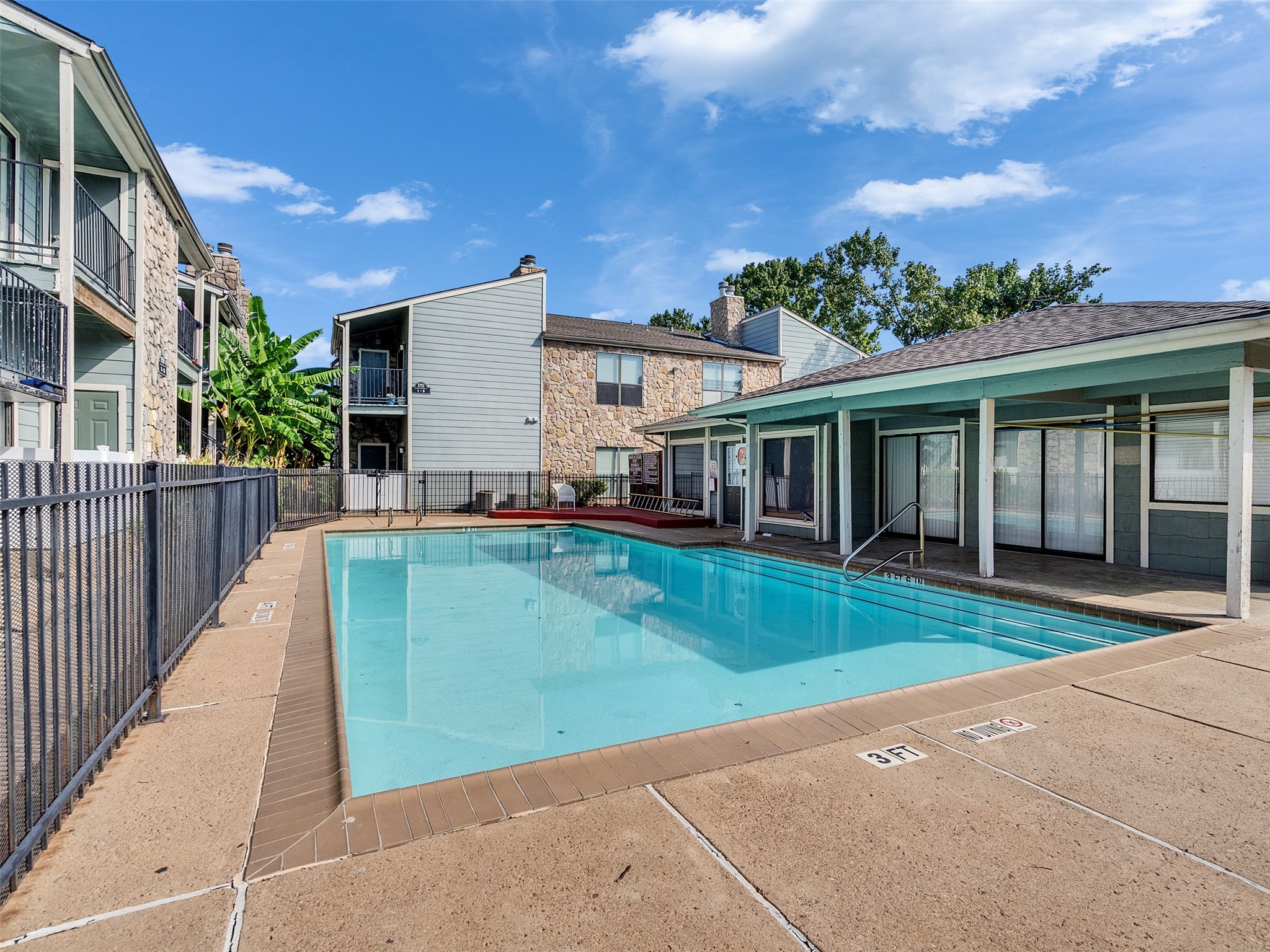 3764 Tanglewilde Street, Unit H8 Houston, TX 77063 - Photo 10 of 22 a view of a white house with a big yard and potted plants