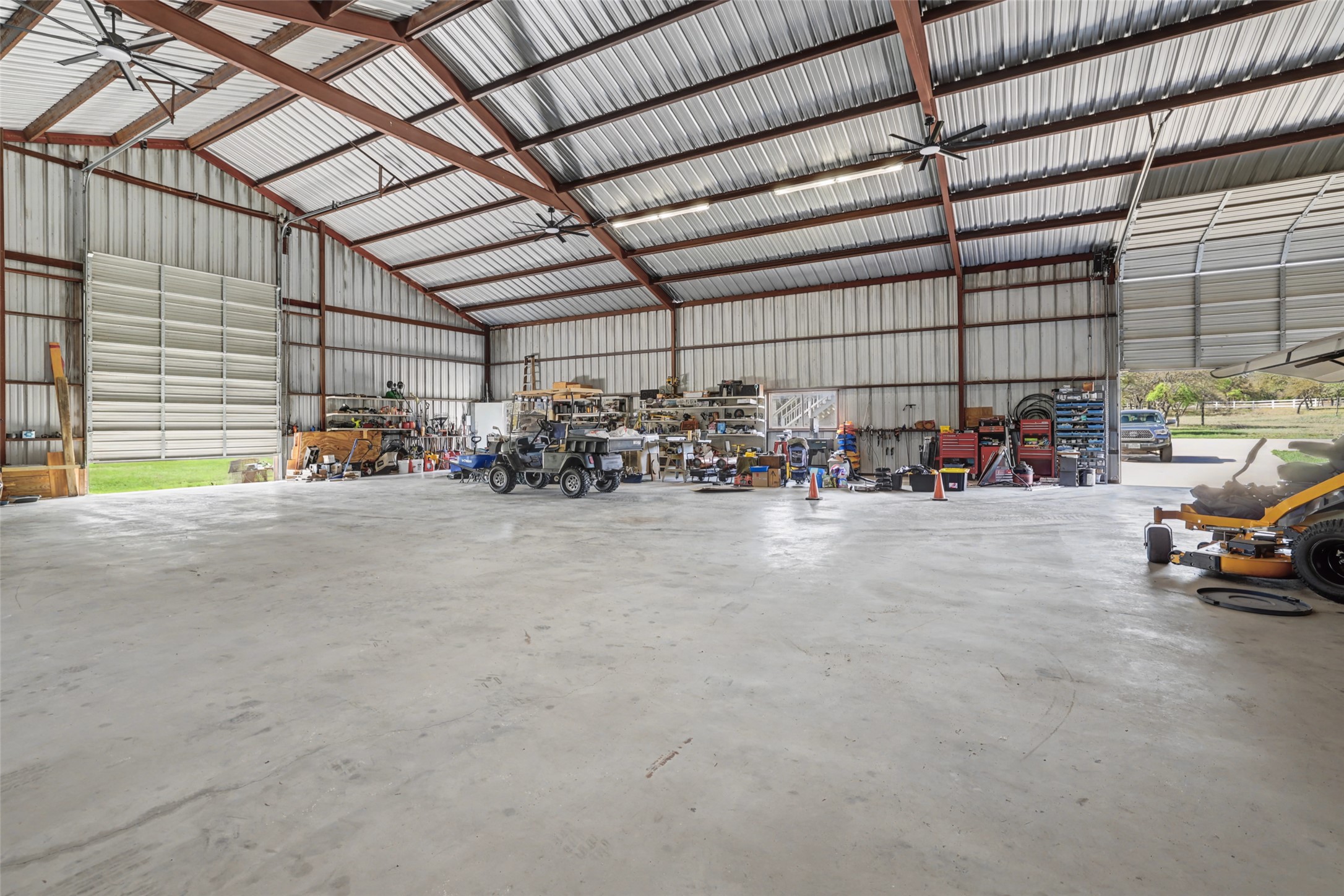 1950 County Road 245 Georgetown, TX 78633 - Photo 34 of 39 INCREDIBLE workshop; 75 X 60 with 2 16' doors 60 amp plug in; electricity; Bring your RV Bring your tractors and Bring your boat