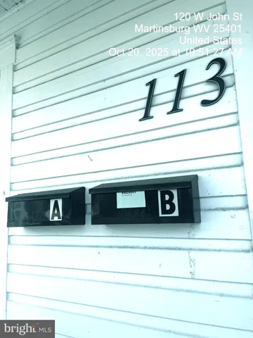 a view of a hallway with wooden floor and a cabinet
