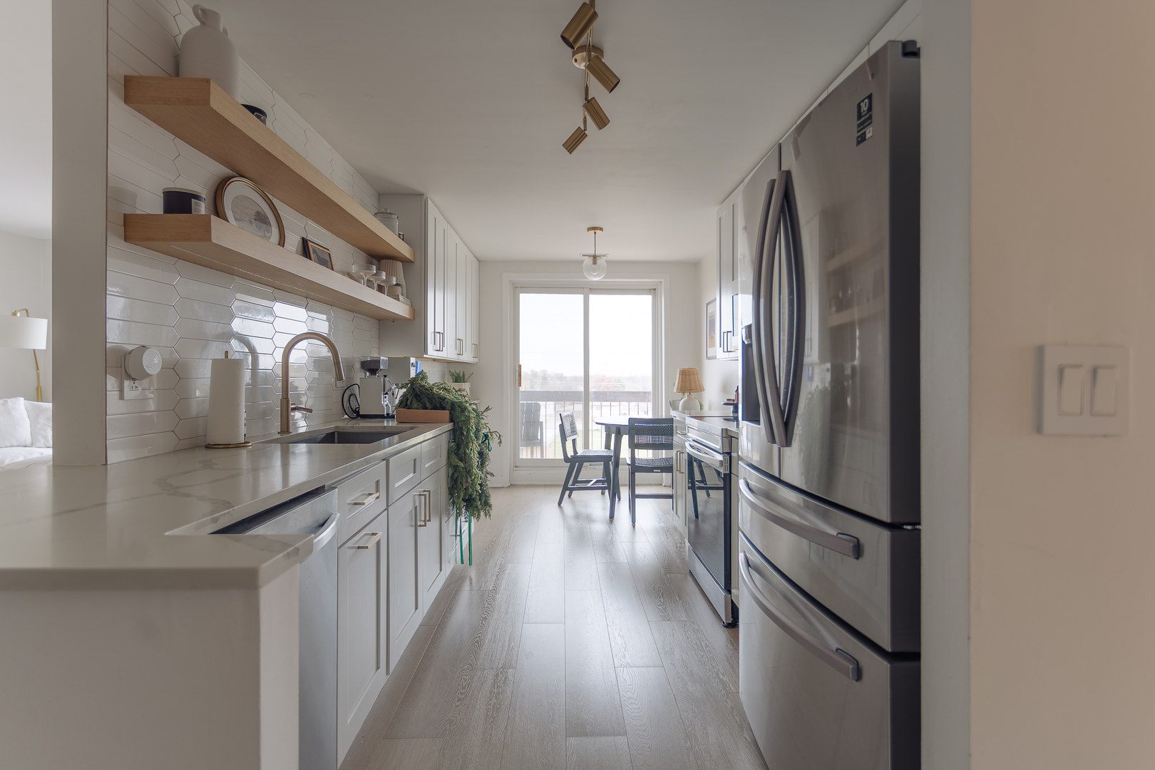 8100 West Foster Lane, Unit 508 Niles, IL 60714 - Photo 15 of 42 a kitchen with granite countertop a refrigerator a sink a stove and cabinets