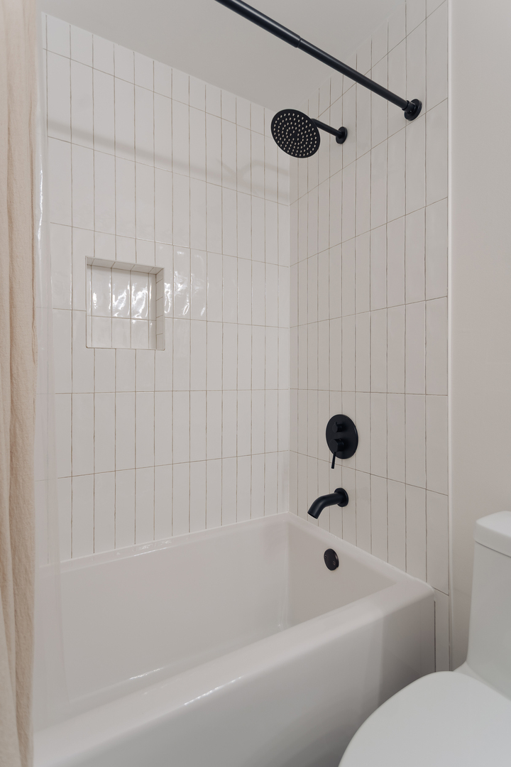 8100 West Foster Lane, Unit 508 Niles, IL 60714 - Photo 25 of 42 a bathroom with a bathtub and a shower