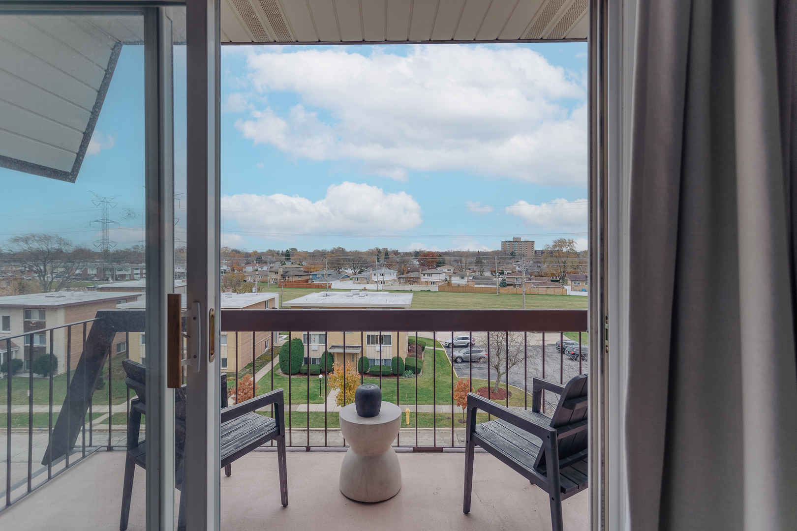 8100 West Foster Lane, Unit 508 Niles, IL 60714 - Photo 35 of 42 a view of a balcony with a potted plant and a glass door