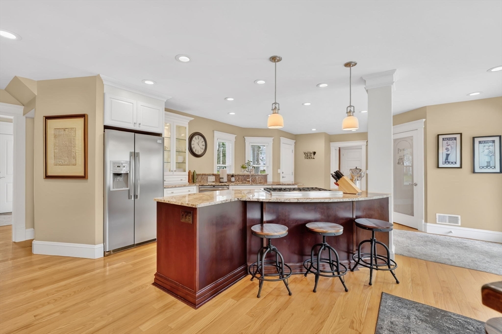 34 Main Street Wilbraham, MA 01095 - Photo 11 of 41 a living room with stainless steel appliances granite countertop furniture wooden floor and kitchen view