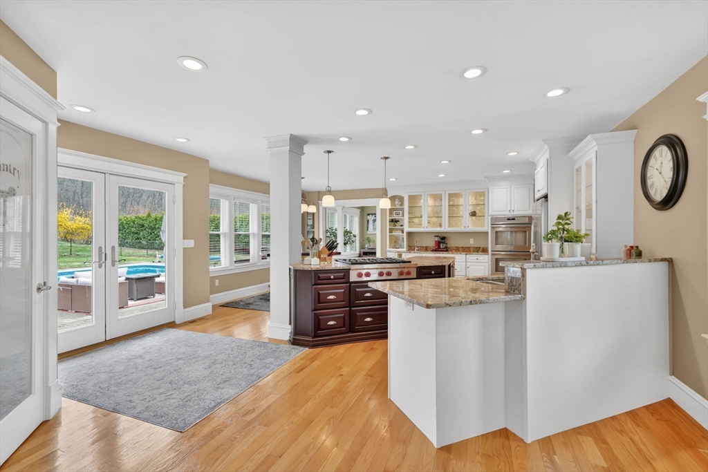 34 Main Street Wilbraham, MA 01095 - Photo 14 of 41 a kitchen with stainless steel appliances kitchen island granite countertop a refrigerator a stove and a sink with large window