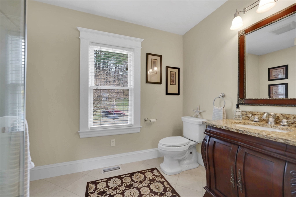 34 Main Street Wilbraham, MA 01095 - Photo 24 of 41 a bathroom with a granite countertop toilet sink and mirror