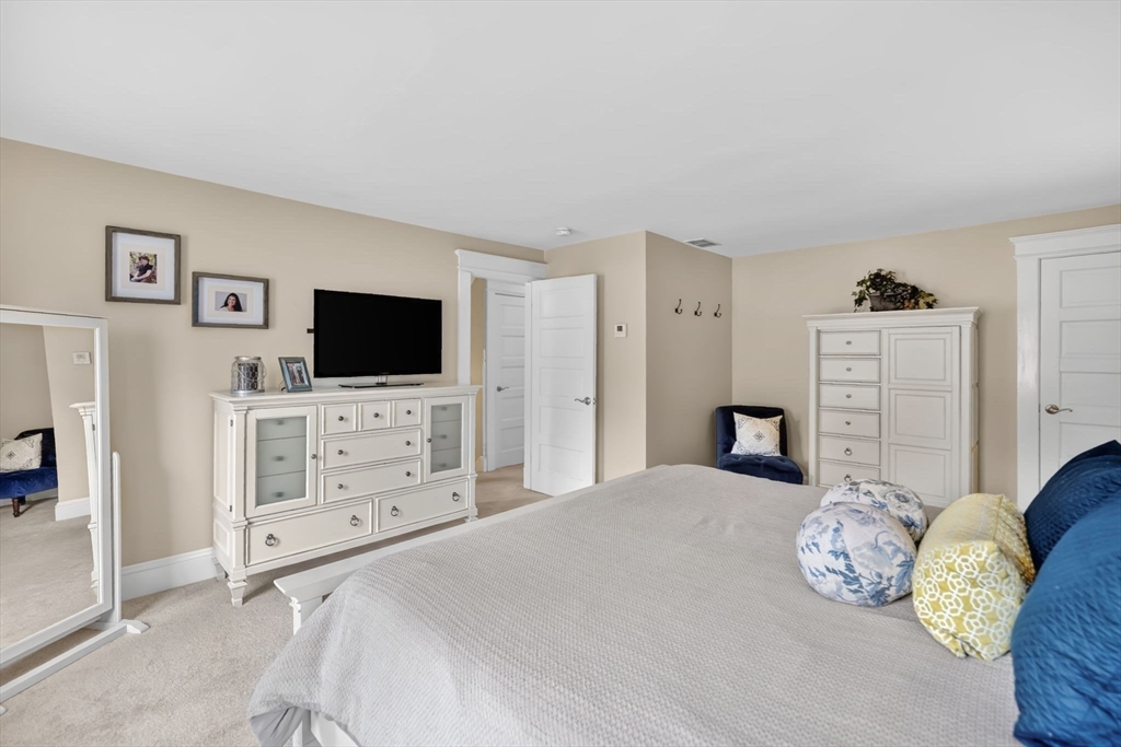 34 Main Street Wilbraham, MA 01095 - Photo 28 of 41 a bedroom with a bed and flat screen tv