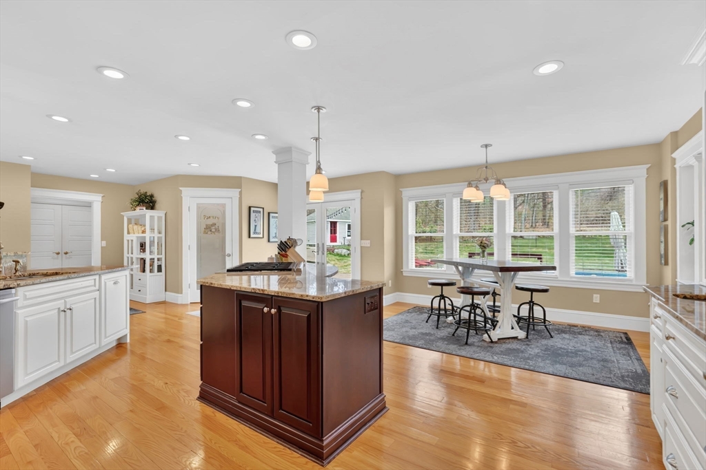 34 Main Street Wilbraham, MA 01095 - Photo 10 of 41 a kitchen with stainless steel appliances granite countertop sink stove and wooden cabinets