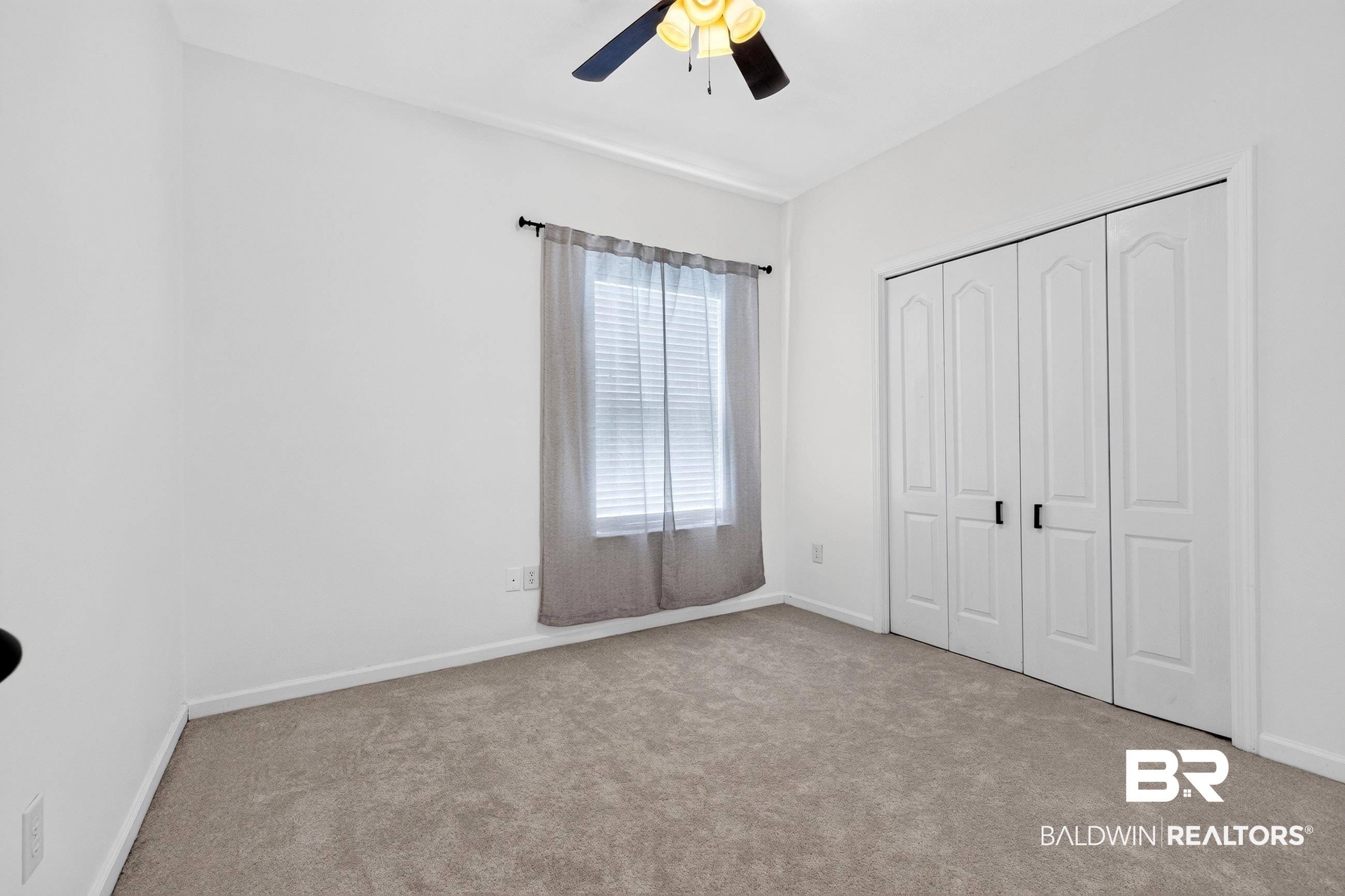 17419 Lewis Smith Drive Foley, AL 36535 - Photo 27 of 38 Bedroom featuring neutral-toned carpeting, white walls, and a ceiling fan with light fixture
