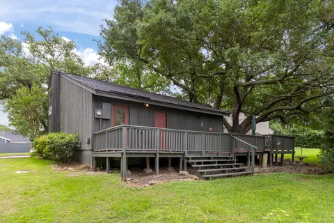 a view of a house with a yard and sitting area