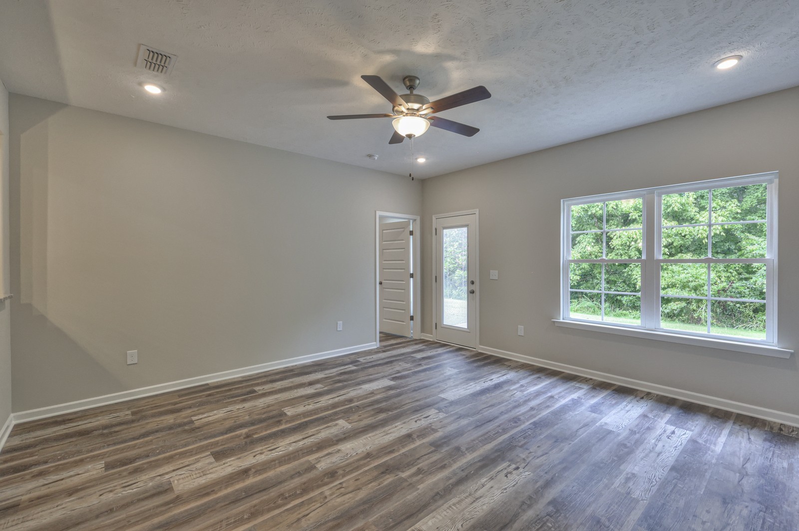 113 Creek Wood Road Manchester, TN 37355 - Photo 15 of 37 a view of an empty room with a window and wooden floor
