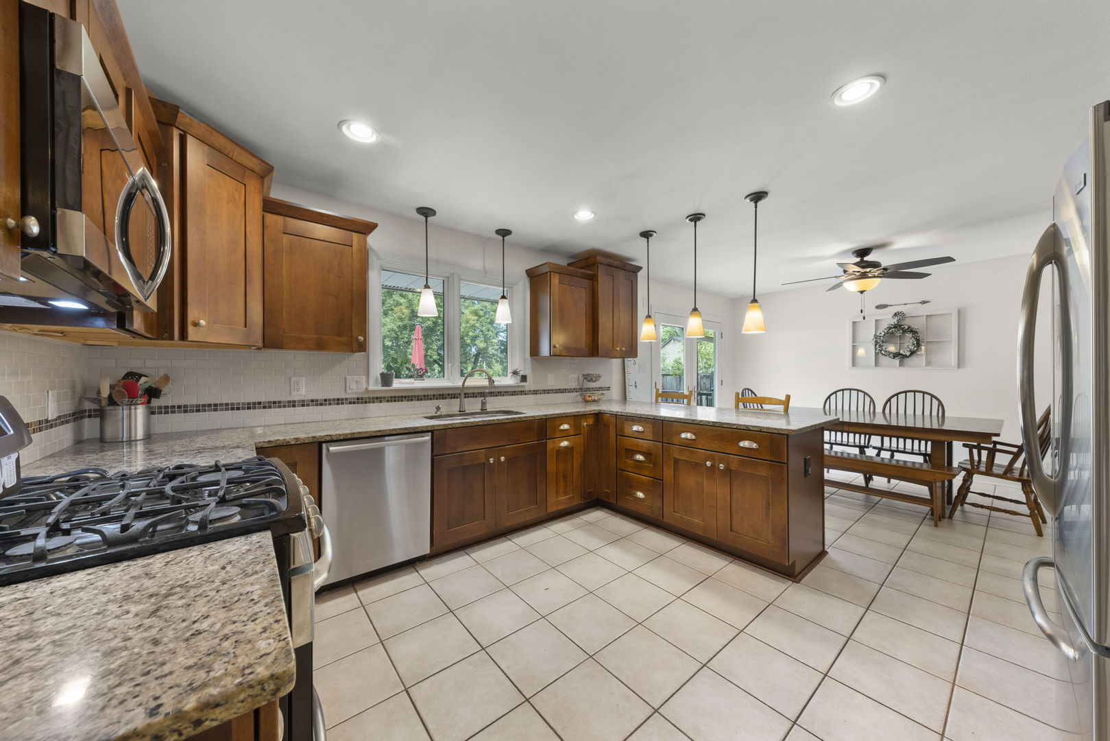 4083 West Sandwich Road Sandwich, IL 60548 - Photo 14 of 74 a kitchen with stainless steel appliances granite countertop a stove a sink and a microwave