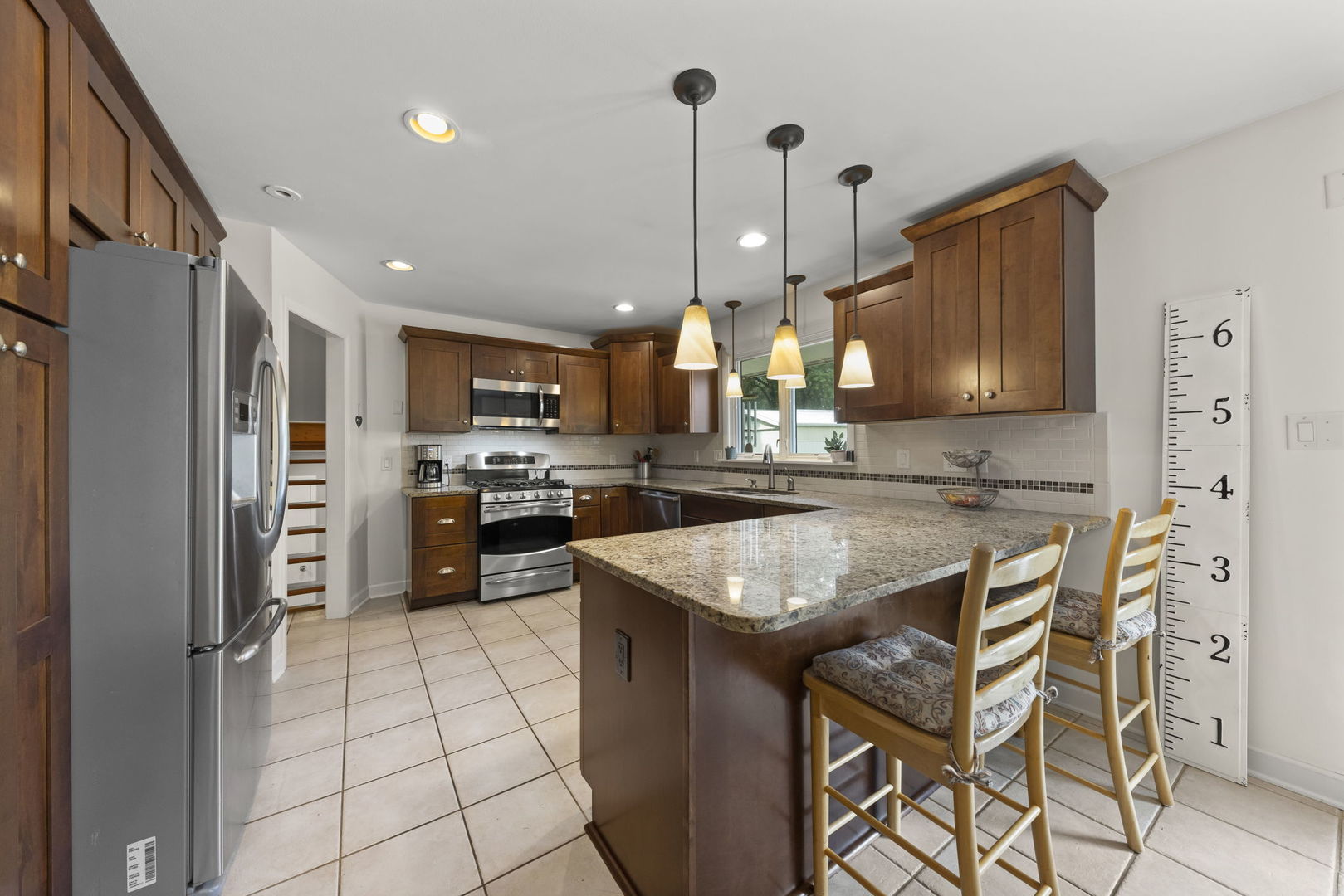 4083 West Sandwich Road Sandwich, IL 60548 - Photo 15 of 74 a kitchen with stainless steel appliances granite countertop wooden cabinets a stove a sink and a refrigerator