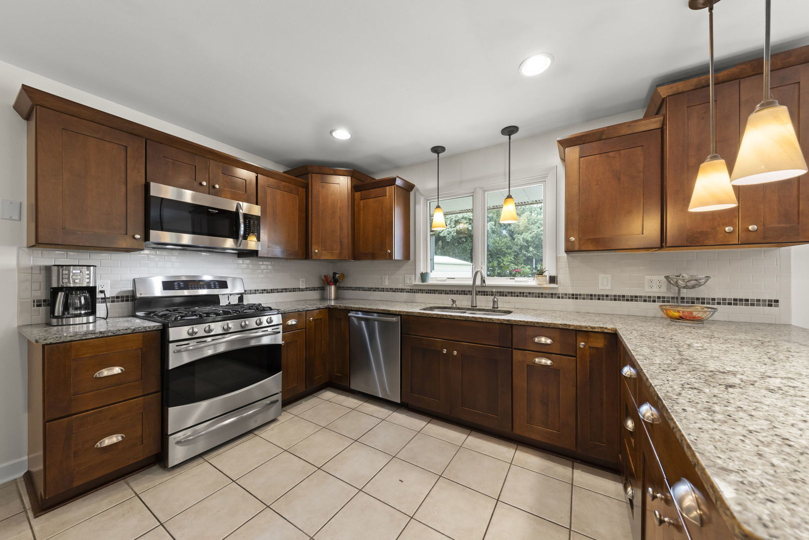 4083 West Sandwich Road Sandwich, IL 60548 - Photo 17 of 74 a kitchen with stainless steel appliances granite countertop wooden cabinets a stove top oven a sink and dishwasher