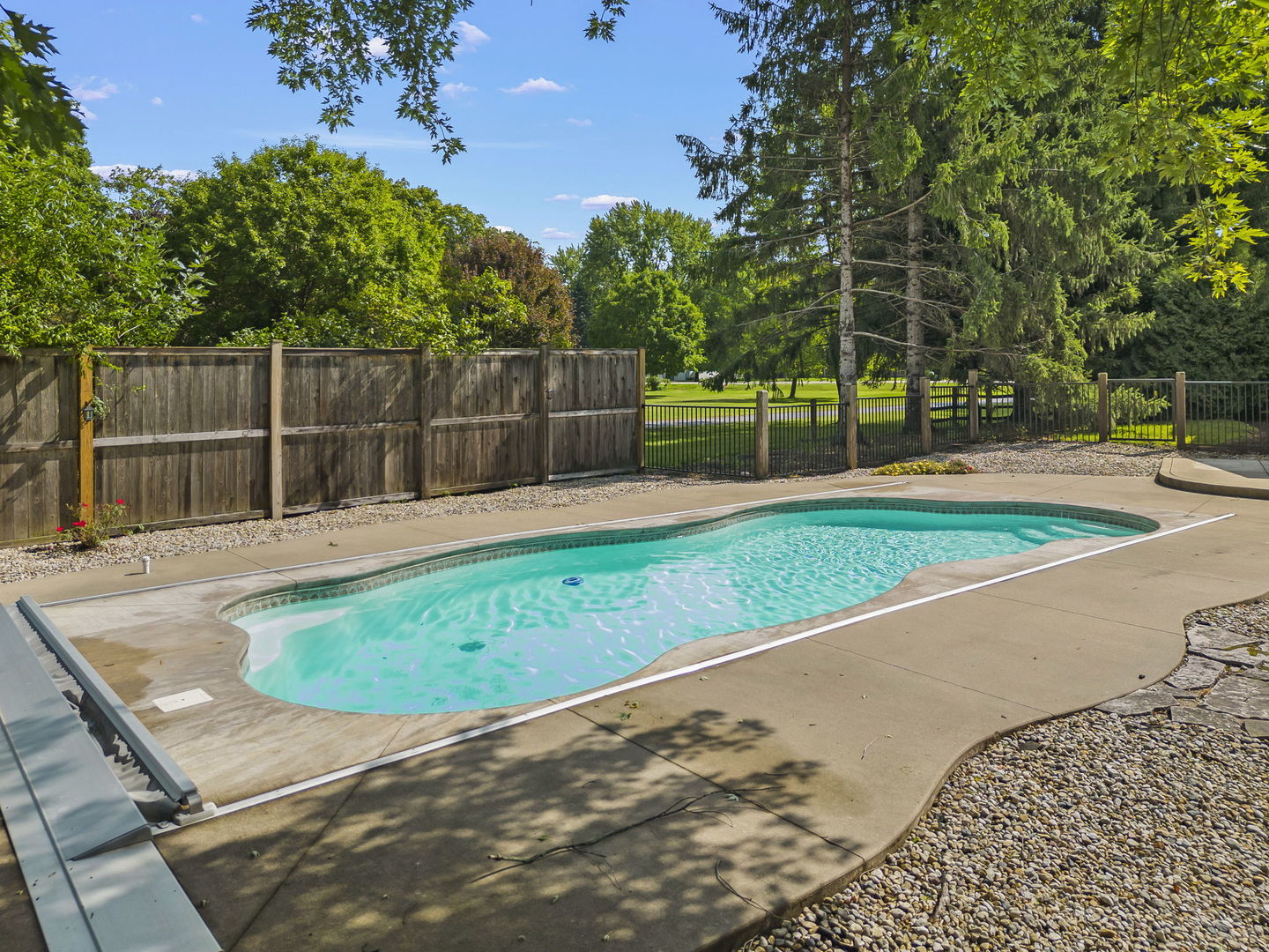 4083 West Sandwich Road Sandwich, IL 60548 - Photo 40 of 74 a swimming pool with some trees in the background