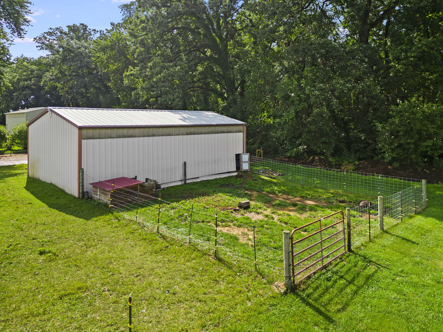 4083 West Sandwich Road Sandwich, IL 60548 - Photo 46 of 74 a view of a white house with a big yard and large trees