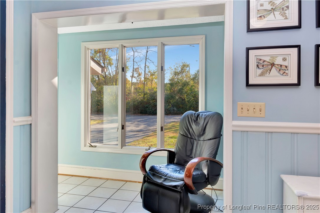 704 B T Road Lumberton, NC 28358 - Photo 16 of 45 a living room with furniture and a floor to ceiling window