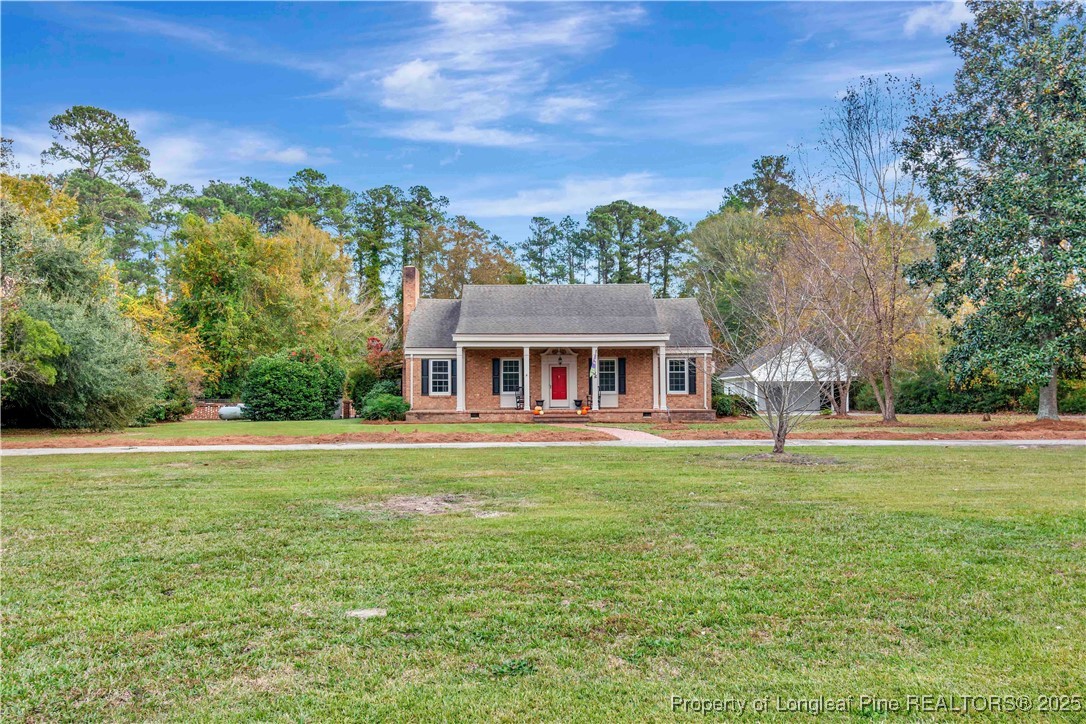 704 B T Road Lumberton, NC 28358 - Photo 2 of 45 a front view of a house with a garden