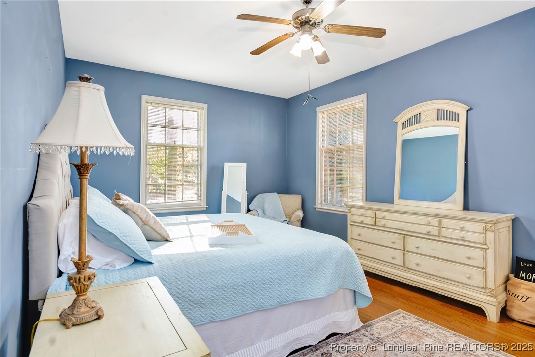 704 B T Road Lumberton, NC 28358 - Photo 23 of 45 a bedroom with a bed a chandelier and dresser
