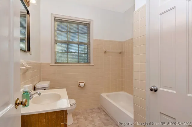a bathroom with a sink toilet and bathtub