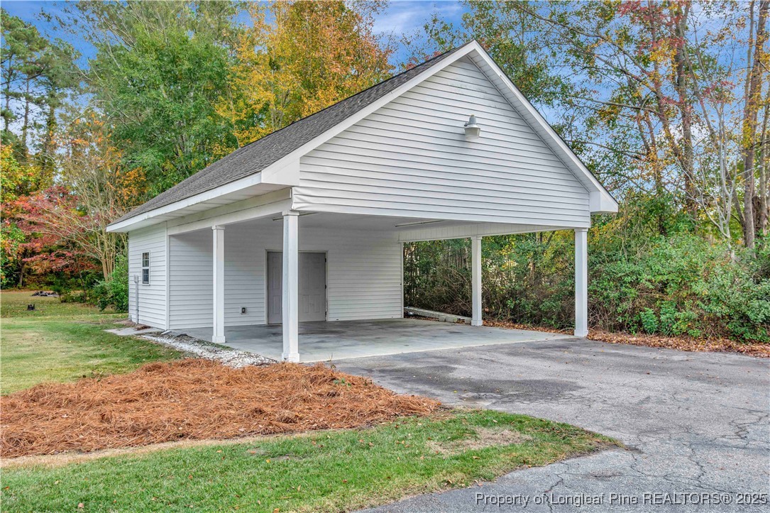 704 B T Road Lumberton, NC 28358 - Photo 40 of 45 a view of a white house next to a yard with large trees