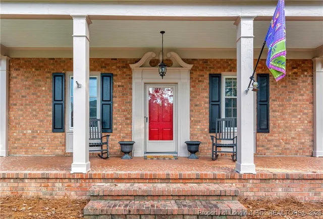 a front view of a building with red door