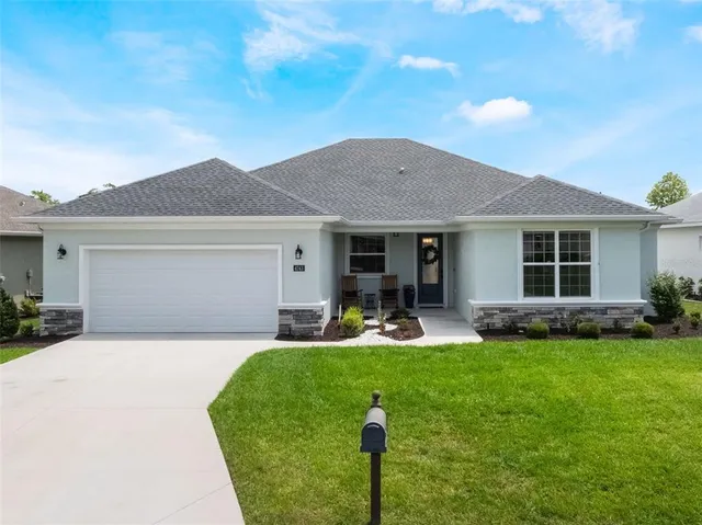 a front view of a house with a yard and porch
