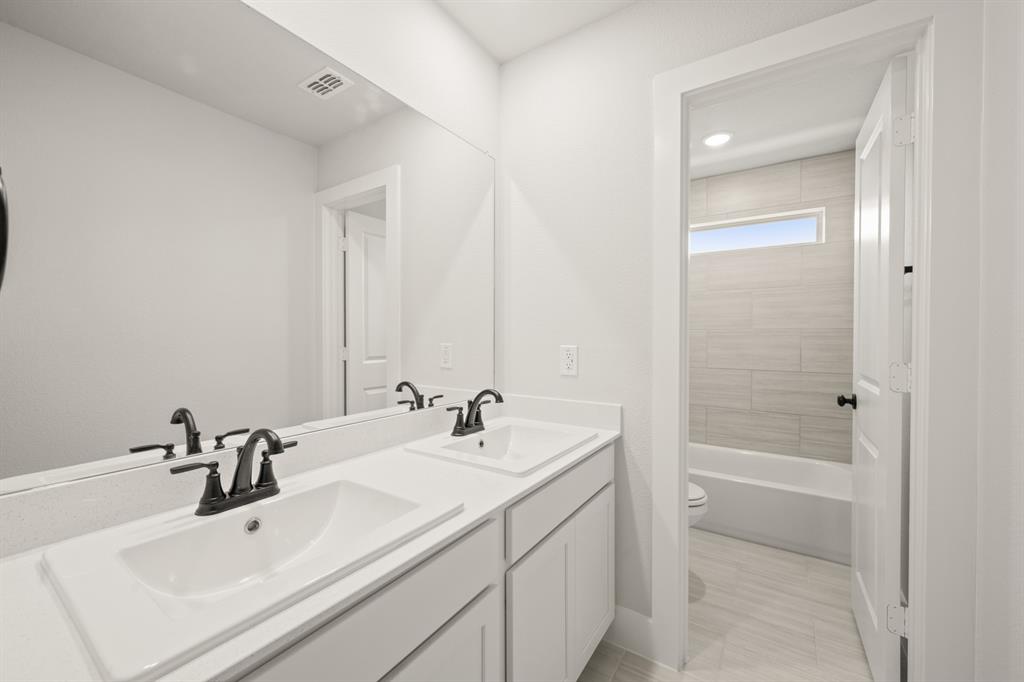 1724 Nesting Robin Lane Krum, TX 76249 - Photo 27 of 40 a bathroom with a sink a shower and a mirror