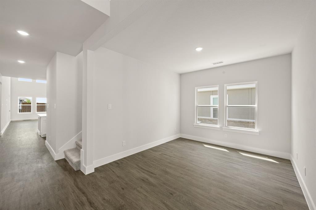 1724 Nesting Robin Lane Krum, TX 76249 - Photo 8 of 40 an empty room with wooden floor and windows