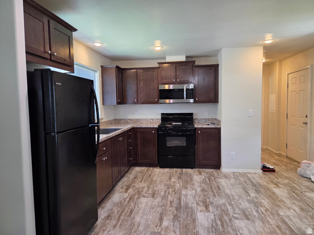 1275 Thrush Road Salt Lake City, UT 84123 - Photo 5 of 20 Kitchen featuring dark wood cabinetry, and speckled countertops