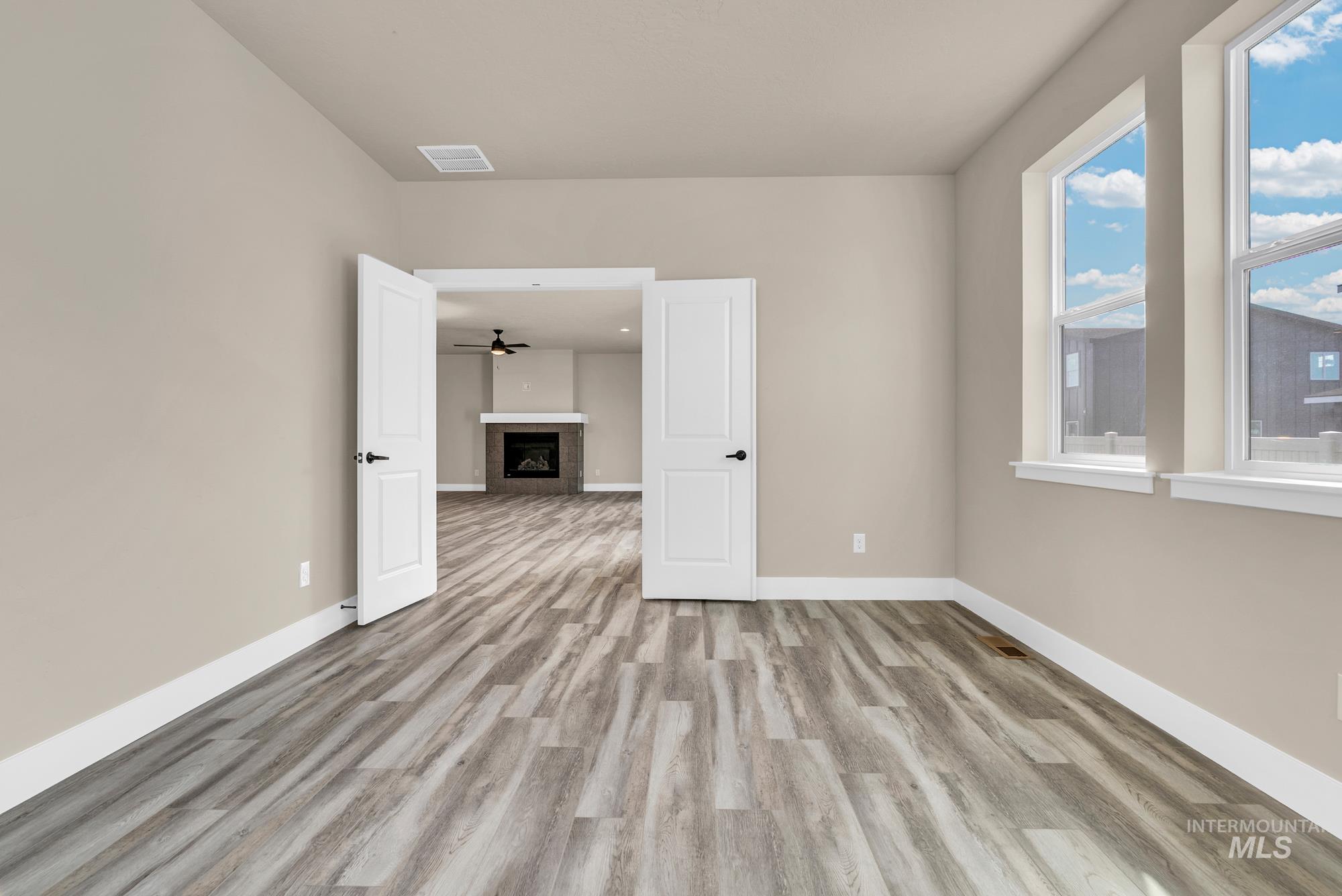 2848 West Jutland Street Meridian, ID 83642 - Photo 10 of 25 Unfurnished room featuring a fireplace and light wood-style flooring