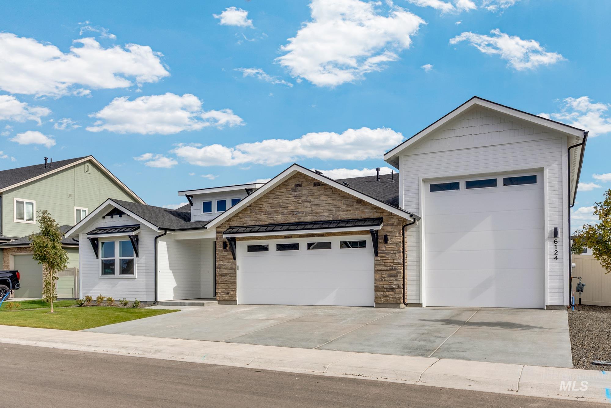 2848 West Jutland Street Meridian, ID 83642 - Photo 2 of 25 View of front facade with a garage, concrete driveway, a shingled roof, and stone siding