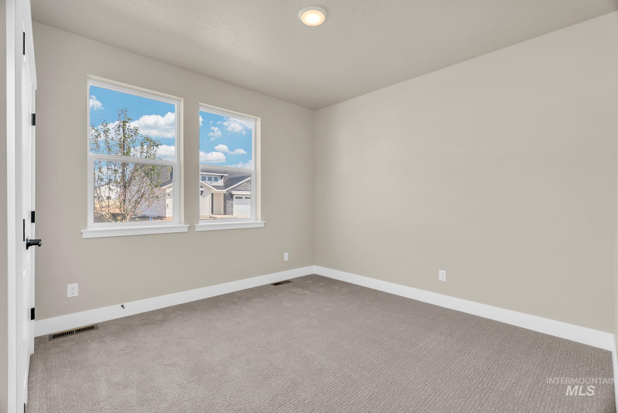 2848 West Jutland Street Meridian, ID 83642 - Photo 20 of 25 Spare room featuring baseboards and light carpet