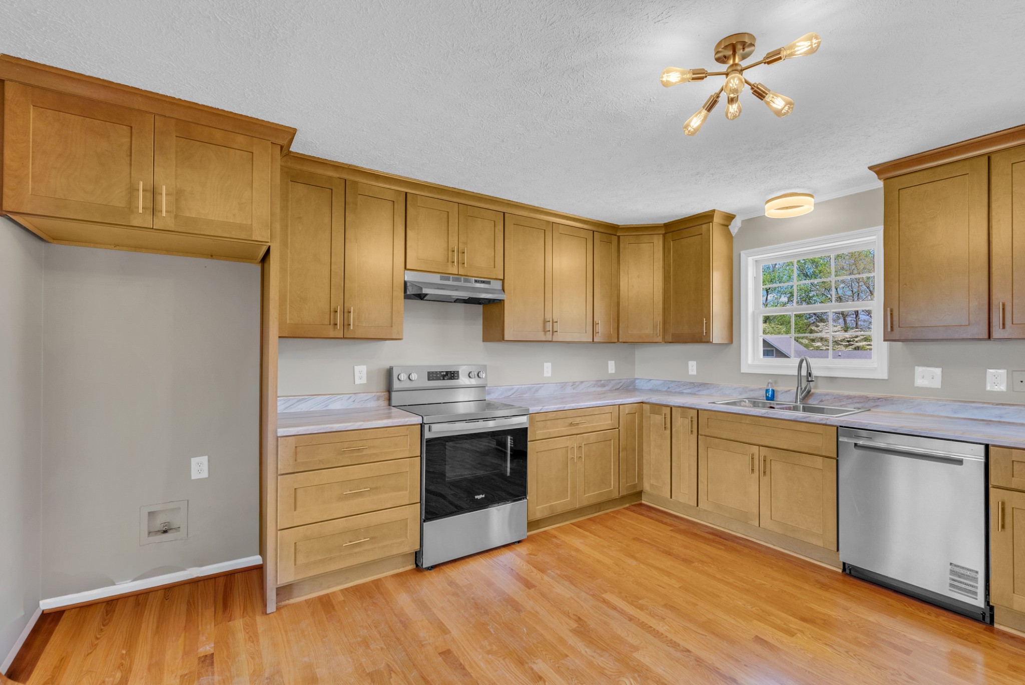 199 Tomahawk Lane Doyle, TN 38559 - Photo 12 of 29 a kitchen with stainless steel appliances granite countertop a sink cabinets and wooden floor