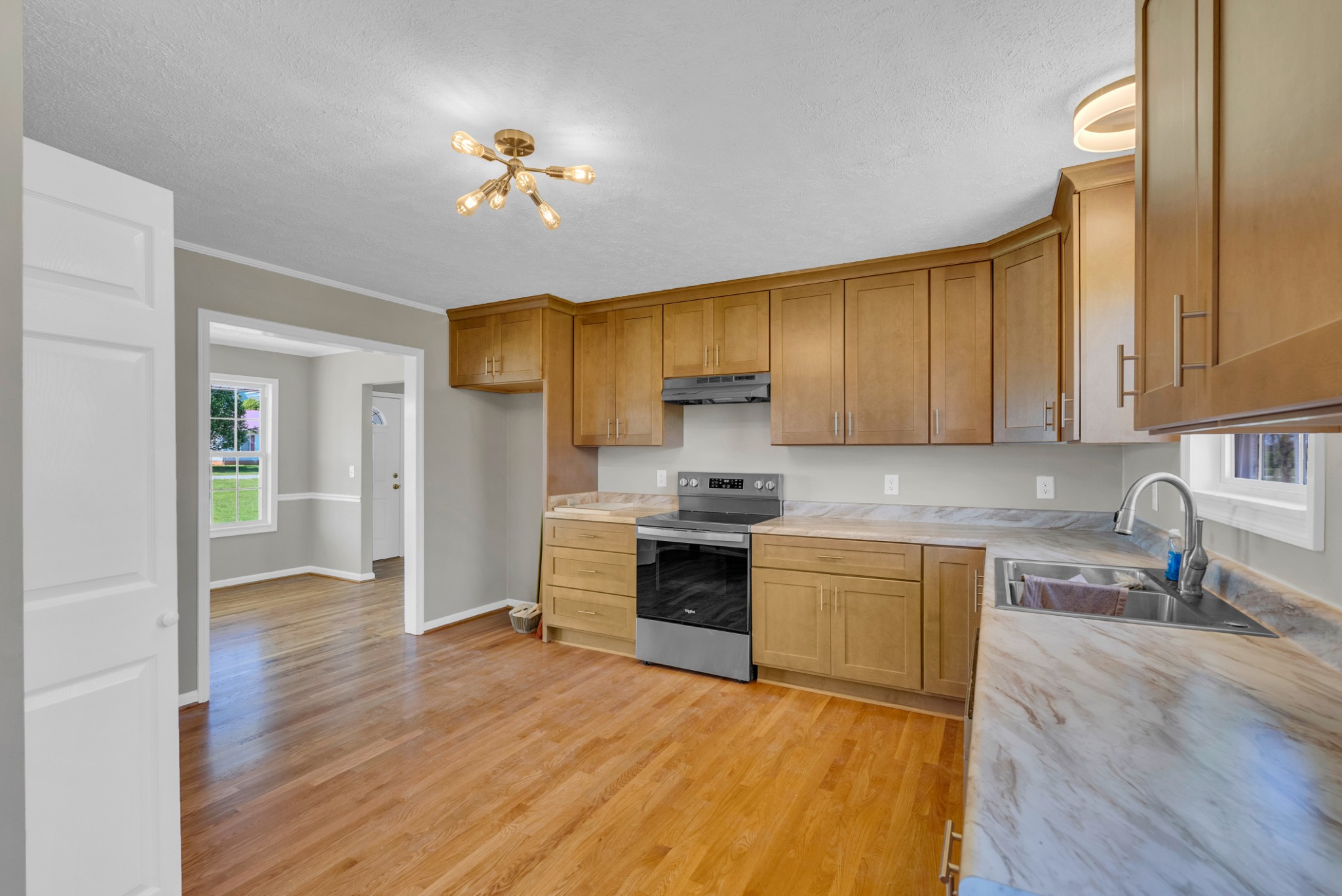 199 Tomahawk Lane Doyle, TN 38559 - Photo 13 of 29 a kitchen with stainless steel appliances granite countertop a refrigerator a sink dishwasher a stove with wooden cabinets and floor