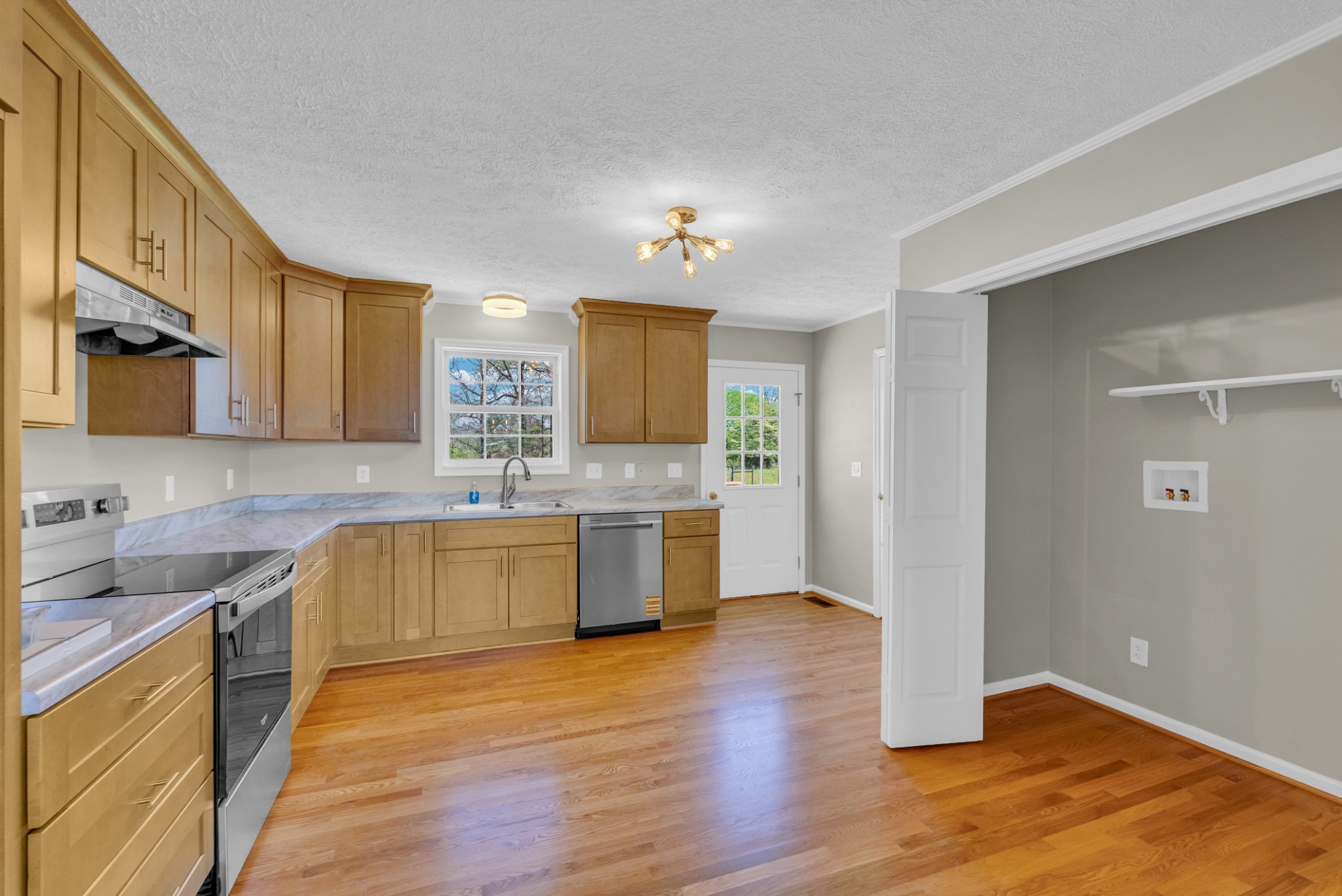 199 Tomahawk Lane Doyle, TN 38559 - Photo 14 of 29 a large kitchen with a wooden floor and large stainless steel appliances
