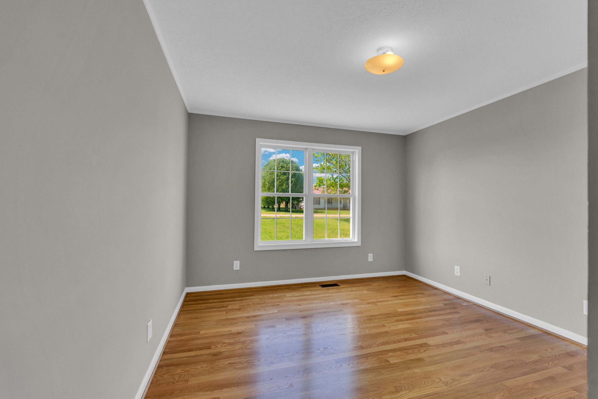199 Tomahawk Lane Doyle, TN 38559 - Photo 25 of 29 a view of an empty room with wooden floor and a window