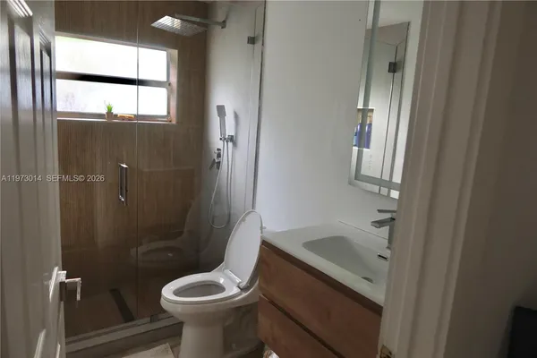 a bathroom with a sink toilet and shower