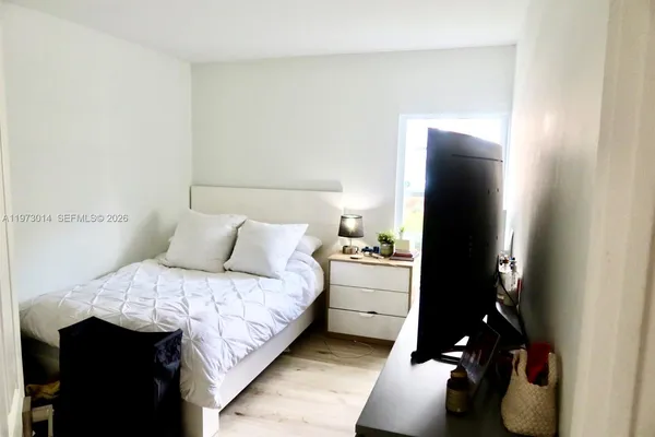 a bedroom with a bed and a night stand