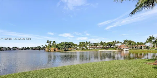 a view of a lake with houses in the back
