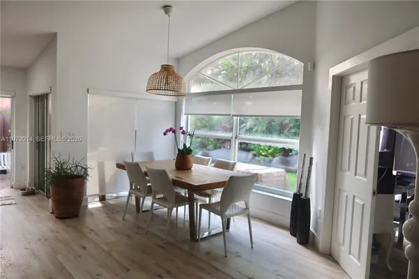 a view of a dining room with furniture window and wooden floor