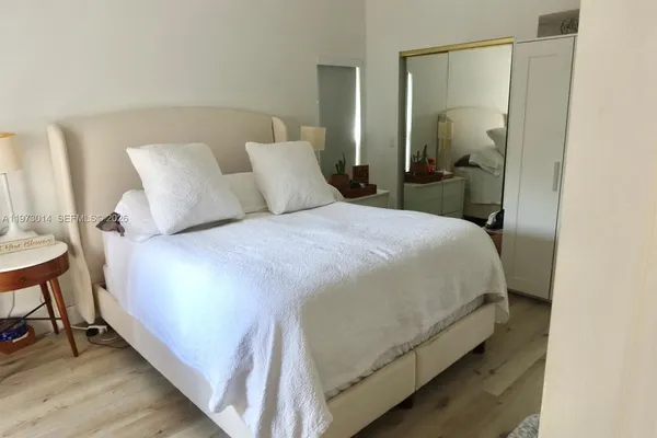 a bedroom with a bed and table chair