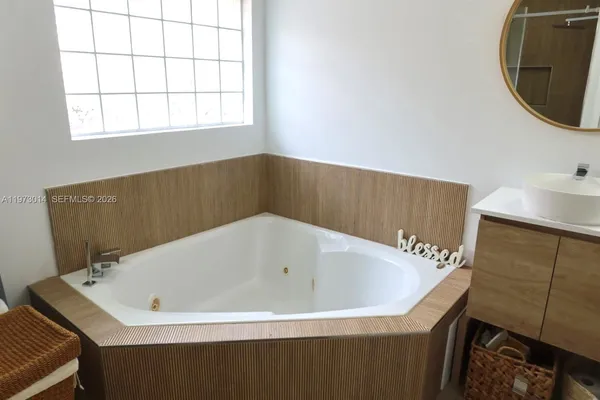 a bathroom with a bathtub and a window