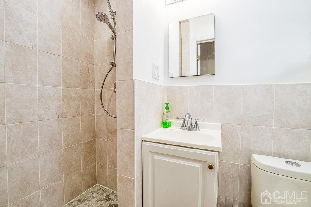2 Peter Avenue Kendall Park, NJ 08824 - Photo 7 of 19 a bathroom with a sink a toilet and shower