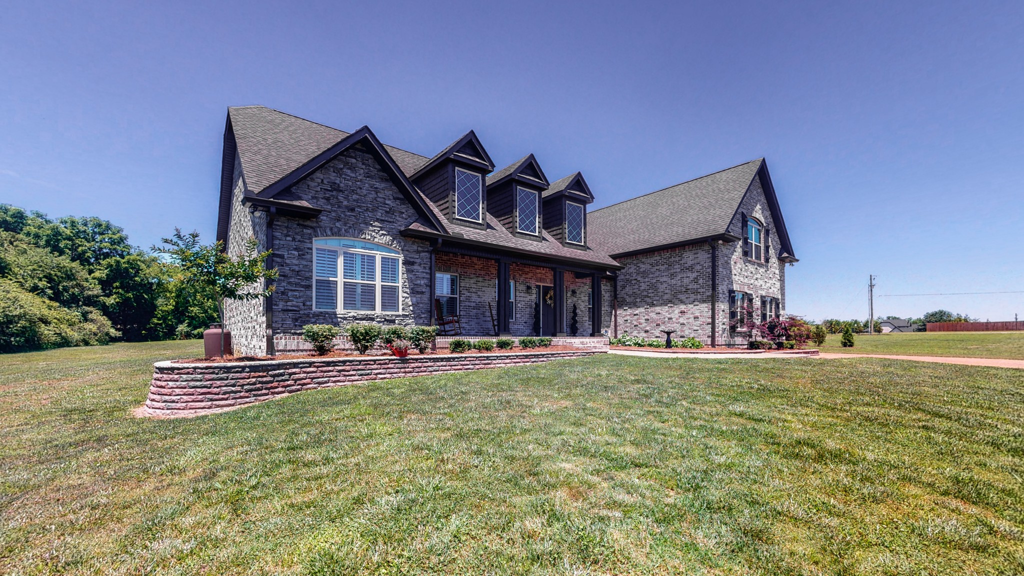 3908 Old Murfreesboro Road West Lebanon, TN 37090 - Photo 4 of 33 a front view of a house with a garden and patio