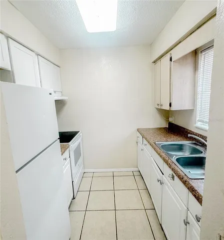 a kitchen with a sink and a stove top oven