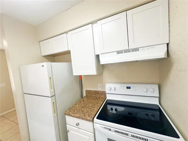 a kitchen with a refrigerator and a sink