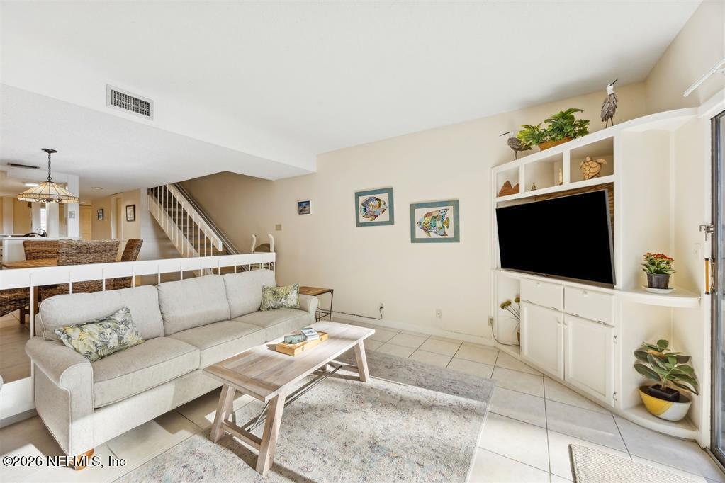 3051 Sea Marsh Road Fernandina Beach, FL 32034 - Photo 12 of 37 a living room with furniture and a flat screen tv