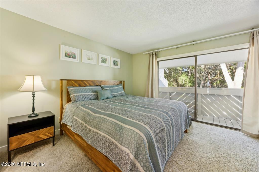 3051 Sea Marsh Road Fernandina Beach, FL 32034 - Photo 20 of 37 a bedroom with a bed and a night stand