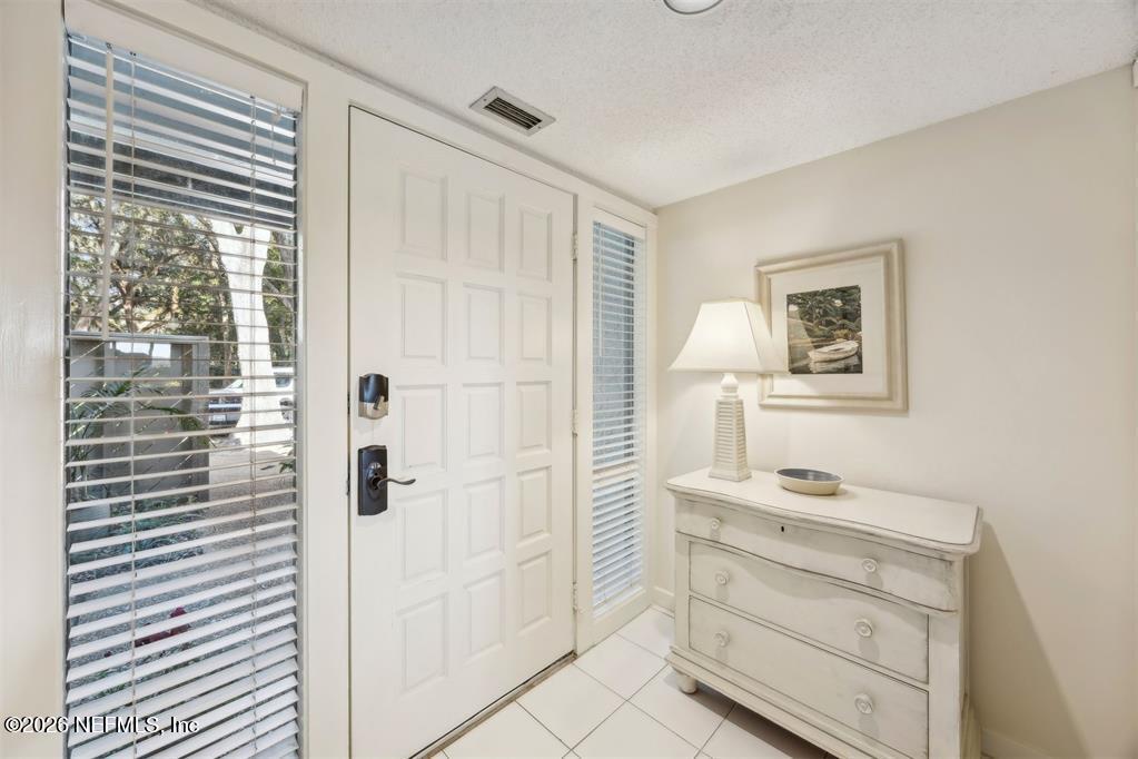 3051 Sea Marsh Road Fernandina Beach, FL 32034 - Photo 5 of 37 a bathroom with a shower a sink and a mirror