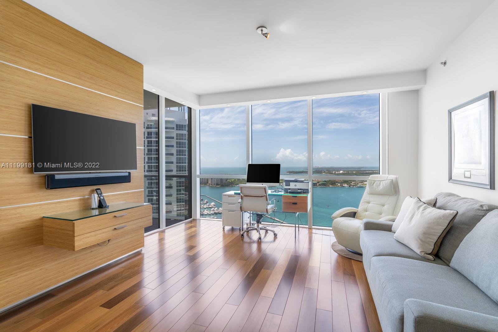450 Alton Road, Unit 3303 Miami Beach, FL 33139 - Photo 13 of 35 a living room with furniture and a flat screen tv